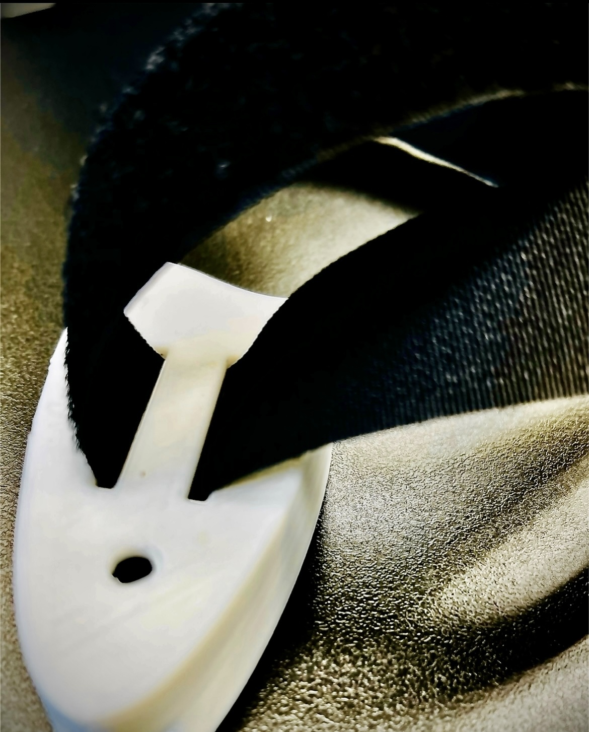 Figure 3 - 3D printed case with straps attached and circular hole that is not big enough for the wire to pass through.